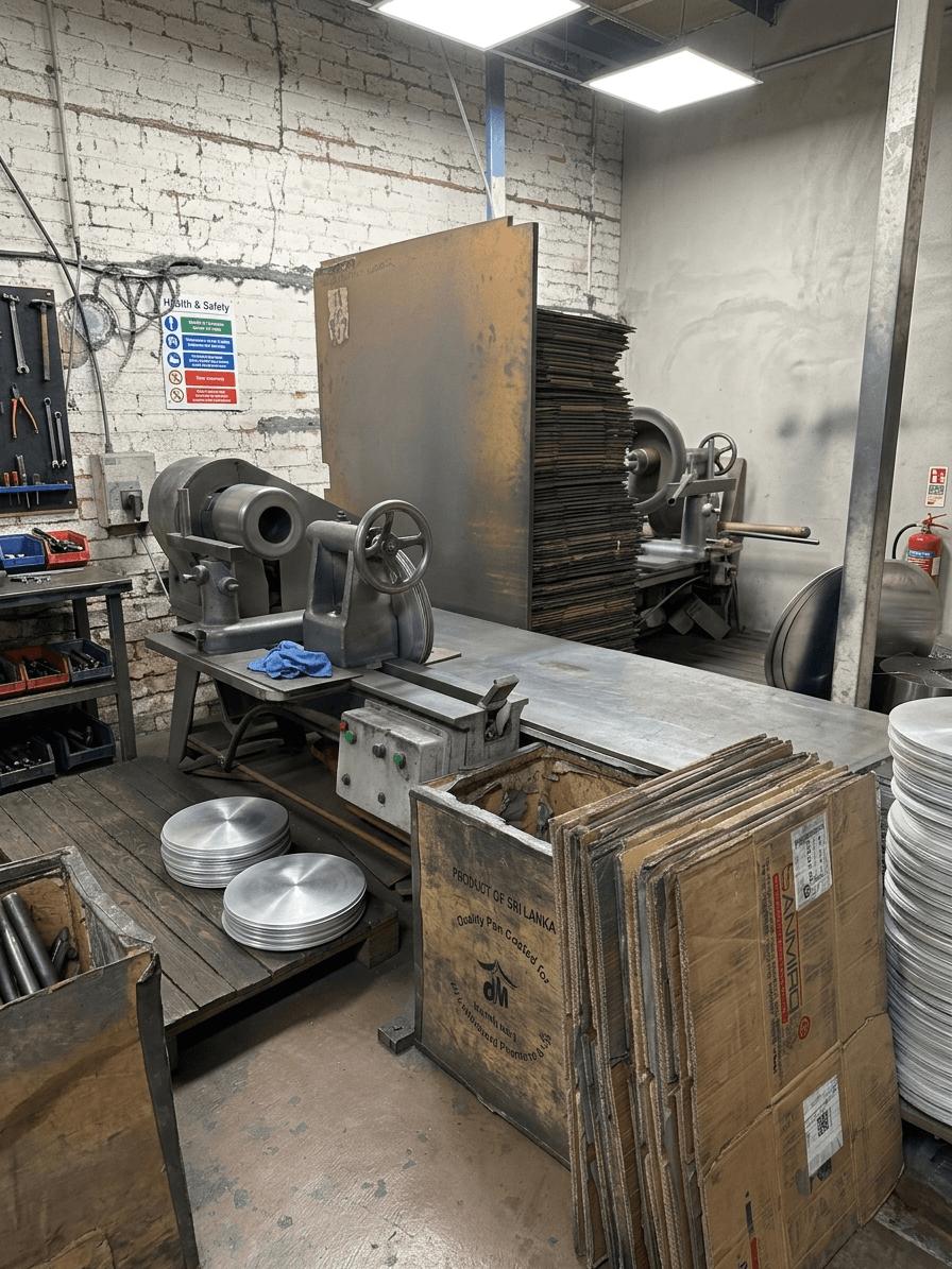 Finishing and polishing station with freshly pressed cookware bases